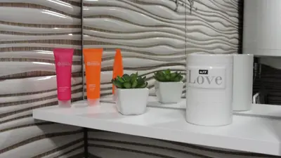 a shelf with different colored vases and plants on it at Apartma Tjaša-Terme Čatež in Čatež ob Savi