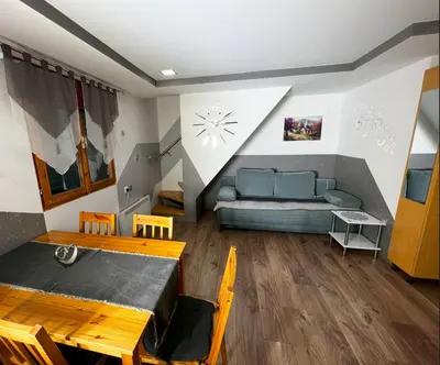 a living room with a couch and a table at Apartma Tjaša-Terme Čatež in Čatež ob Savi
