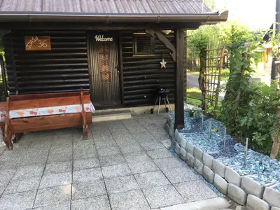 a wooden bench sitting in front of a building at Apartma Tjaša-Terme Čatež in Čatež ob Savi