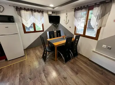 a kitchen and dining room with a table and chairs at Apartma Tjaša-Terme Čatež in Čatež ob Savi