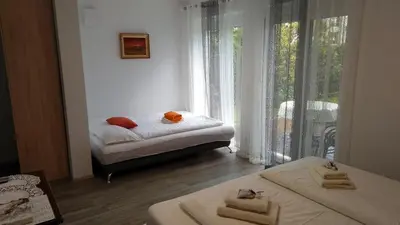 a bedroom with two beds and a window at Apartma Golob in Zgornja Kungota