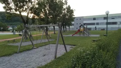 a playground with a swing set in a park at Apartma Golob in Zgornja Kungota