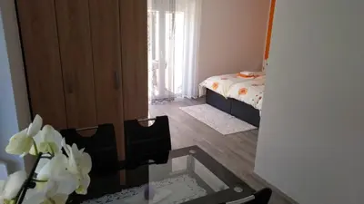 a room with a table and a bedroom with a bed at Apartma Golob in Zgornja Kungota