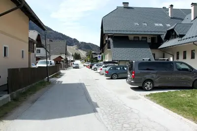 a street with cars parked on the side of a building at Apartment Via Mons in Kranjska Gora