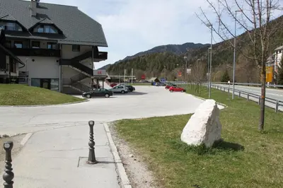 a large rock sitting on the side of a road at Apartment Via Mons in Kranjska Gora