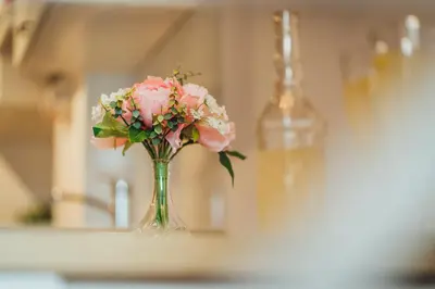 a vase filled with pink flowers on a table at Apartment Via Mons in Kranjska Gora