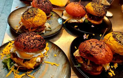 a group of sandwiches on plates on a table at Apartments & Burgers REZIDENCA PIPANOVA in Ljubljana