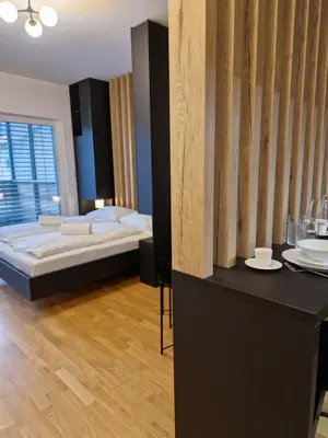a bedroom with a bed and a table with plates on it at Apartments & Burgers REZIDENCA PIPANOVA in Ljubljana