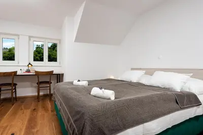 a bedroom with a large bed with two towels at Fani&Rozi B&B in Maribor
