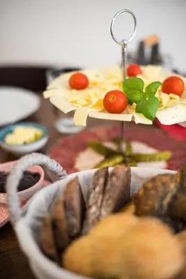 a table with a plate of food on a table at Fani&Rozi B&B in Maribor