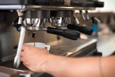 a person is preparing a cup of coffee at Fani&Rozi B&B in Maribor