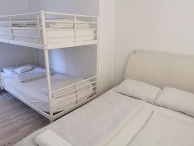 a small bedroom with a bunk bed and a bunk bed at Most Hostel in Ljubljana