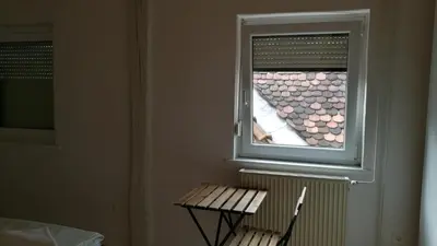 a window in a room with a bench in front of it at Most Hostel in Ljubljana