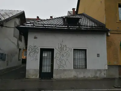 a white building with graffiti on the side of it at Most Hostel in Ljubljana