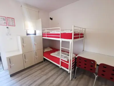 a small room with two bunk beds in it at Most Hostel in Ljubljana