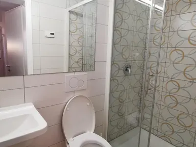 a bathroom with a toilet and a sink and a shower at Most Hostel in Ljubljana