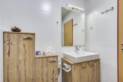a bathroom with a sink and a mirror at J&M Holiday Home Moravske Toplice in Moravske Toplice