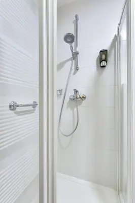 a shower with a shower head in a bathroom at J&M Holiday Home Moravske Toplice in Moravske Toplice