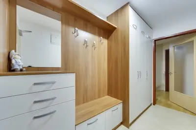 a dressing room with white cabinets and a mirror at J&M Holiday Home Moravske Toplice in Moravske Toplice