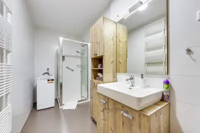 a white bathroom with a sink and a shower at J&M Holiday Home Moravske Toplice in Moravske Toplice