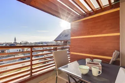 a balcony with a table and a view at J&M Holiday Home Moravske Toplice in Moravske Toplice