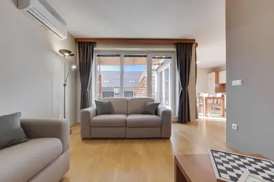 a living room with a couch and a table at J&M Holiday Home Moravske Toplice in Moravske Toplice