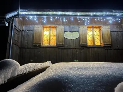 a bedroom with two windows with lights on them at Velika planina Chalet SLOVENKA in Stahovica