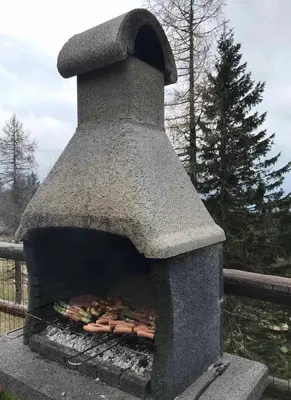 a stone oven with food inside of it at Velika planina Chalet SLOVENKA in Stahovica