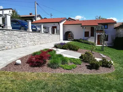 a garden in front of a house at Prenočišča Iris in Sežana