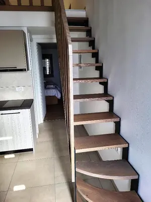 a staircase with wooden steps in a room at Prenočišča Iris in Sežana