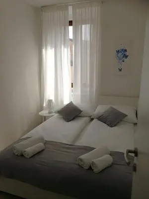 a bedroom with a large bed with two pillows on it at Apartments B&M in Sežana