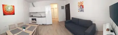 a living room with a couch and a kitchen at Apartments B&M in Sežana