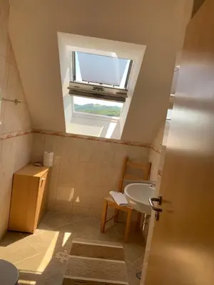 a bathroom with a sink and a window at Hostel Strug in Makole