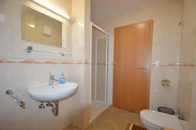 a bathroom with a sink and a toilet and a shower at Hostel Strug in Makole