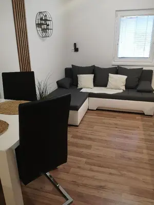 a living room with a couch and a table at Alpine Joy Apartments in Bohinj