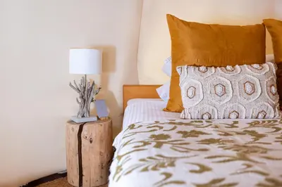 a bedroom with a bed and a lamp on a table at Glamping Gozdna Jasa in Bovec
