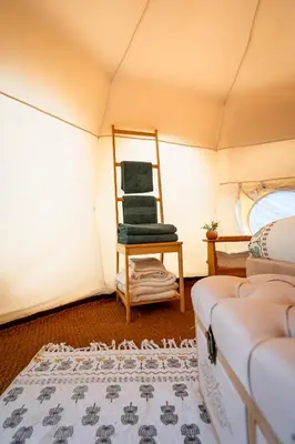 a room with a chair in a tent at Glamping Gozdna Jasa in Bovec
