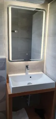 a bathroom with a white sink and a mirror at Apartments and Rooms Milena in Kranjska Gora