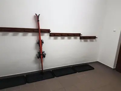 a wall with a sword in a room with mats at Apartments and Rooms Milena in Kranjska Gora