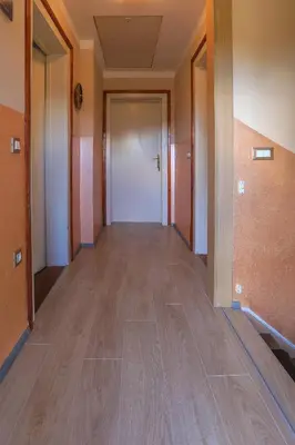 an empty hallway of an office building with wooden floors at Apartments Pr Fajfarju in Bled