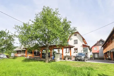 a tree in the yard of a house at Apartments Pr Fajfarju in Bled