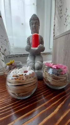 a statue of a person sitting on a table with a candle at Apartments Violeta in Bled