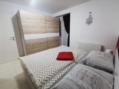 a bedroom with a bed with a red pillow at Apartments Violeta in Bled