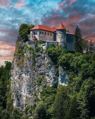 a castle on the side of a mountain at Apartments Violeta in Bled