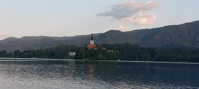 a church on an island in the middle of a lake at Apartments Violeta in Bled