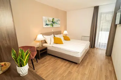 a hotel room with a bed and a chair at Penzion Šterk in Most na Soči