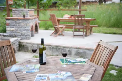 a table with a bottle of wine and two glasses at Apartments Bobi in Tolmin