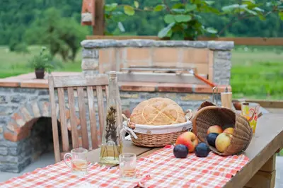 a picnic table with a basket of fruit on it at Apartments Bobi in Tolmin