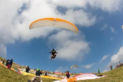 a man flying through the air with a parachute at Apartments Bobi in Tolmin