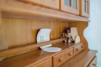 a wooden cabinet with two appliances on top of a counter at Lizina hiška House Bohinj in Bohinjska Bistrica